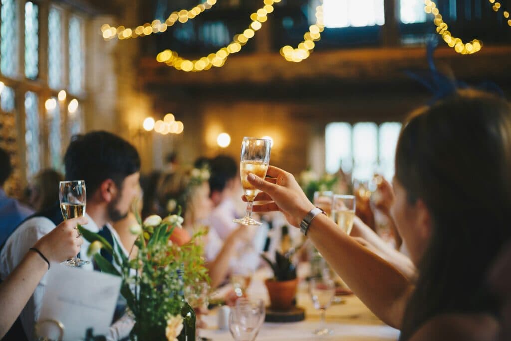 Guests raising their glasses at a celebratory dinner