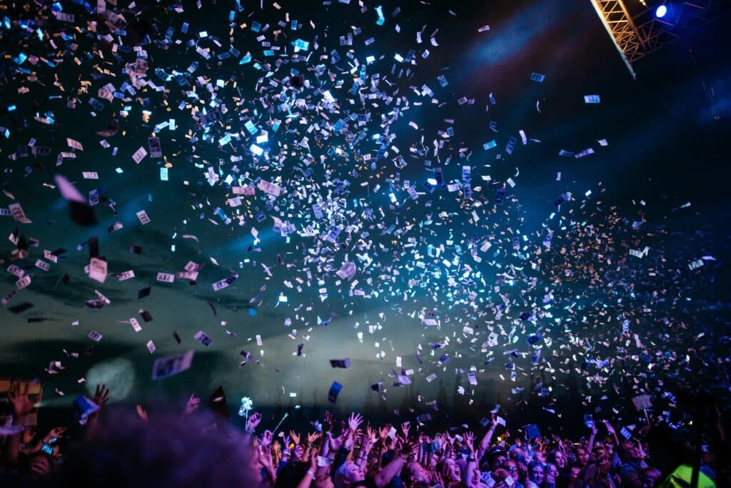 Confetti falling over a lively event crowd