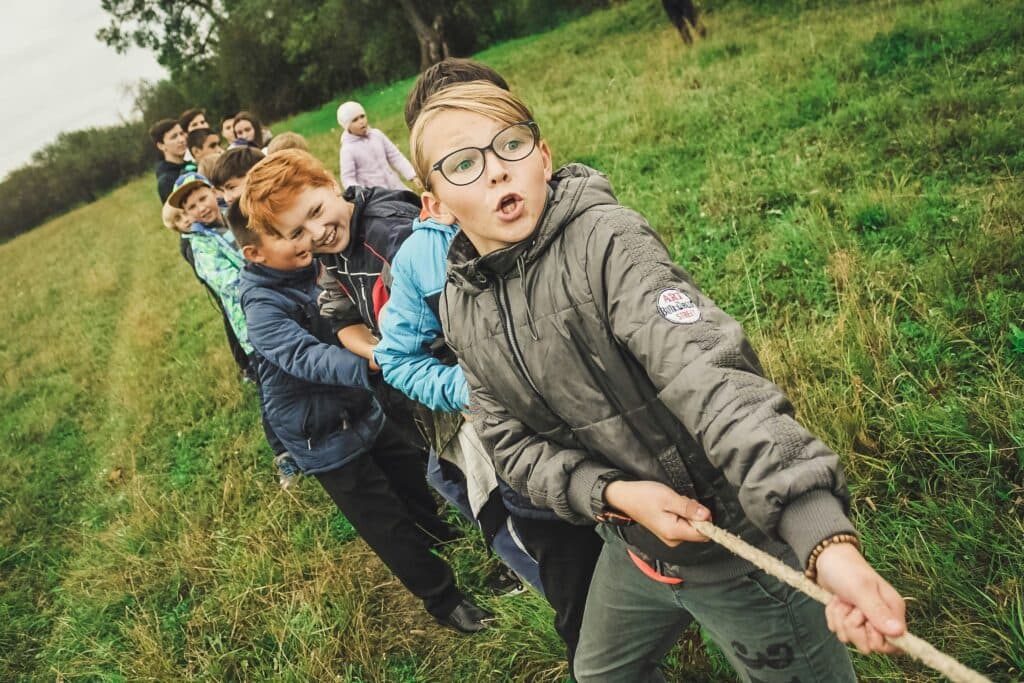 A team working together in an outdoor tug-of-war
